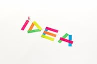 Creative concept with colorful paper cutouts spelling 'IDEA' against a white background.